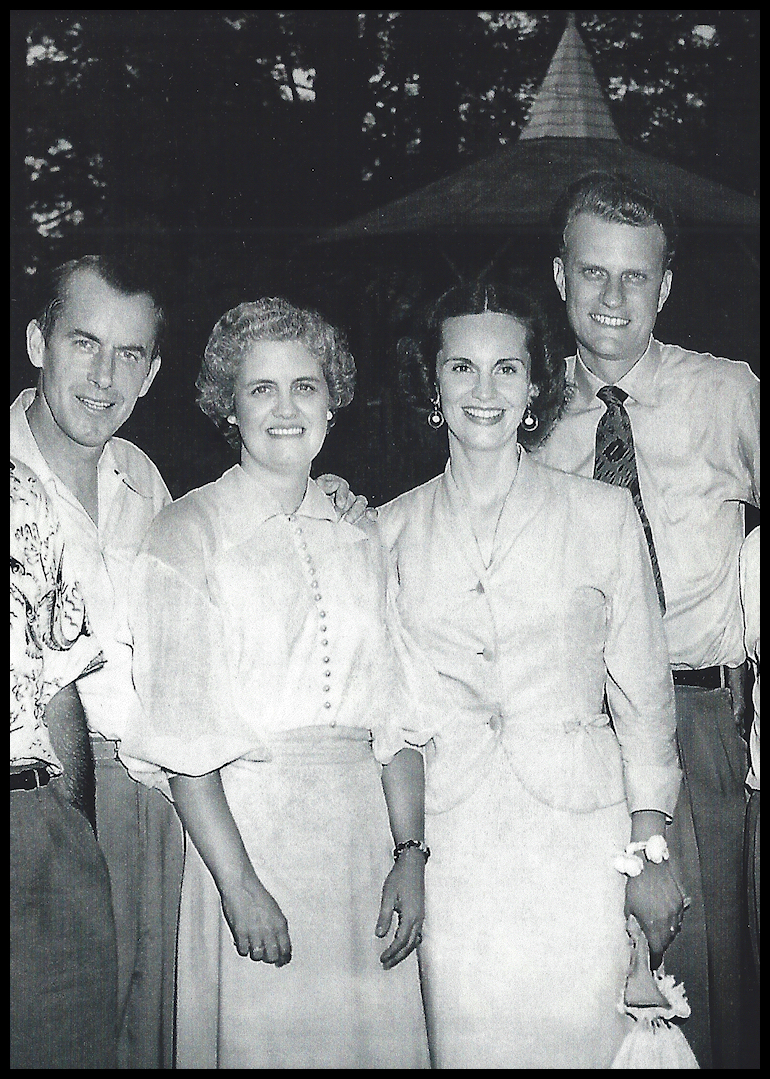 black and white photo: two well-dressed and handsome
            smiling couples in a semi-formal pose